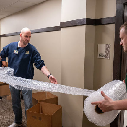 Notre Dame staff pack up student books and other requested items needed for the remote classes announced as a response to the COVID19 outbreak. (Photo by Matt Cashore/University of Notre Dame)