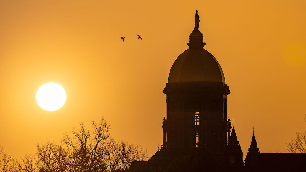 Sunrise behind the Main Building (Photo by Matt Cashore/University of Notre Dame)