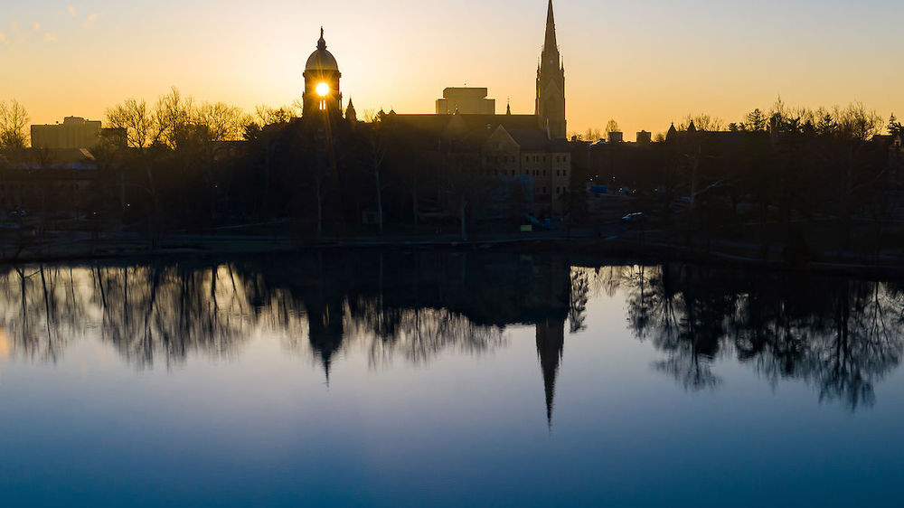 Sunrise behind campus skyline (Photo by Matt Cashore/University of Notre Dame)