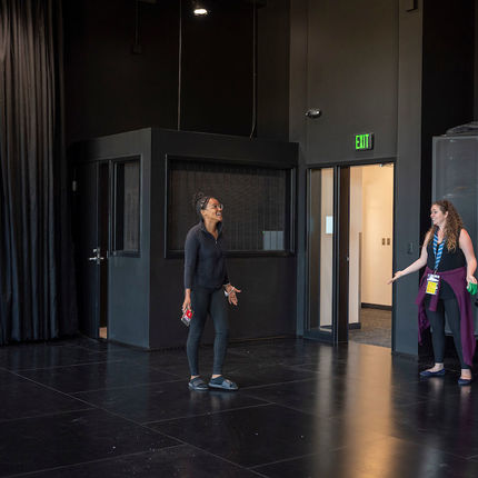Christy Burgess, Shakespeare outreach director, (right) shows one of her students Tiana Mudzimurema the Black Box rehearsal room at the new Robinson Community Learning Center (RCLC) in South Bend. (Photo by Barbara Johnston/University of Notre Dame)
