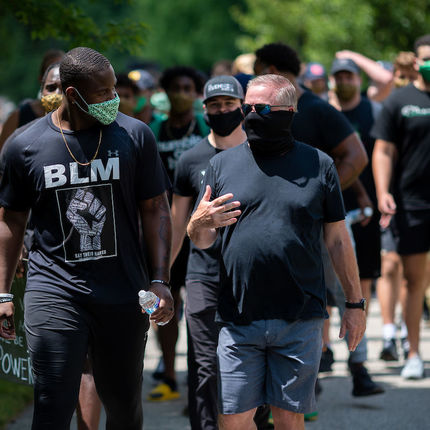 Football player Daelin Hayes (left) and Head Coach Brian Kelly lead their teammates and other participants on a walk through campus in recognition of Juneteenth.(Photo by Matt Cashore/University of Notre Dame)