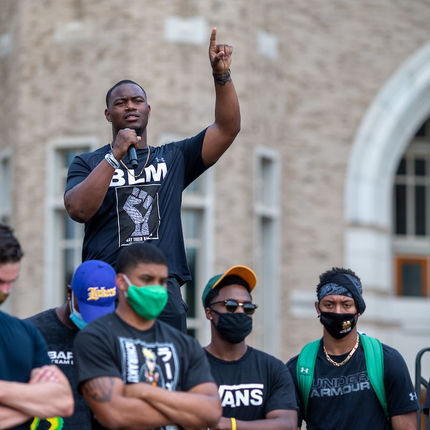 Football player Daelin Hayes speaks at a rally on the Irish Green. Members of the Notre Dame football team lead participants on a walk through campus in recognition of Juneteenth.