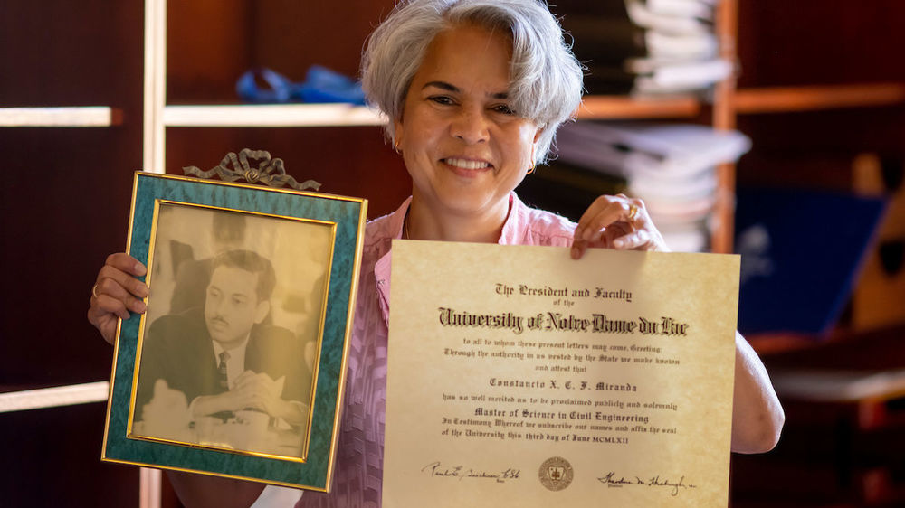 Provost Marie Lynn Miranda holds a photo of her father and his 1962 Notre Dame Master of Civil Engineering degree. (Photo by Matt Cashore/University of Notre Dame)