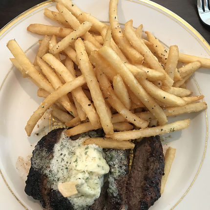 Steak (grilled sirloin) frites served with roasted garlic parsley butter, made to order.  (Photo by Natalie Davis Miller)