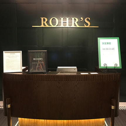 Rich dark wood panels and front desk are part of the re-imagined Rohr's.