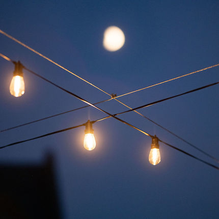 Edison lights cast a warm glow on South Lawn Commons. Photo by Matt Cashore/University of Notre Dame