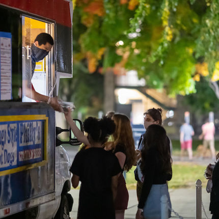 Students gather around a food truck on LIbrary Lawn. Photo by Matt Cashore/University of Notre Dame.