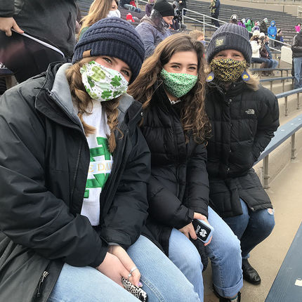 Denise Wager, right, who works in the Notre Dame Law School, and daughters and Notre Dame students Abby and Claire cheer on the Irish.