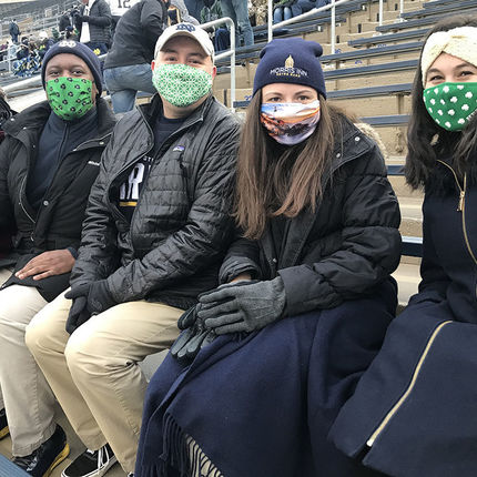 Carrie Ann Taylor, Brandan Lee, Pablo Sweeney, Katie Price, all guest services associates at the Morris Inn, join Alyssandra Howe, gifts development student worker, in cheering on the Irish to a win over Syracuse.
