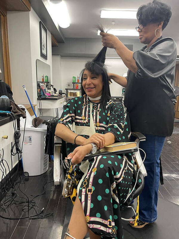 Consuelo Wilson, director of the Office of Student Enrichment, has her hair styled by Yvette Wade at University Hair Stylists.