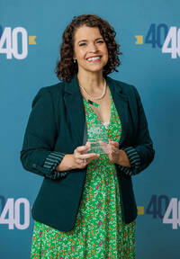 Photo of Bethany Cohen holding her Forty under 40 award.