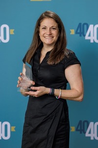 Photo of Allison Slabaugh holding her Michiana Forty under 40 award.