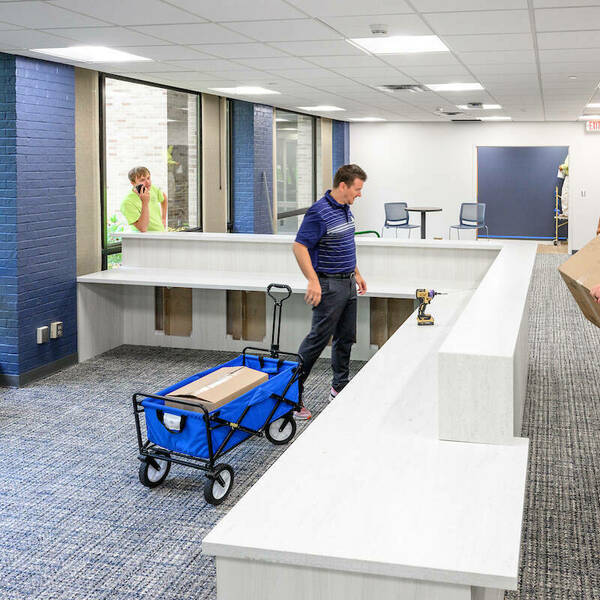 Left to right: Mike Hovestol, left, and Stephen Weaver of the Irish1 Card office, check out the reception area of the new office space on the first floor of Grace Hall, in the space formerly occupied by Cafe De Grasta. (Photo by Matt Cashore/University of Notre Dame)