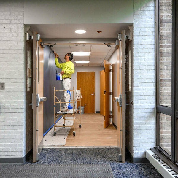 Workers put the finishing touches on the new office space on the first floor of Grace Hall, in the space formerly occupied by Cafe De Grasta. (Photo by Matt Cashore/University of Notre Dame)