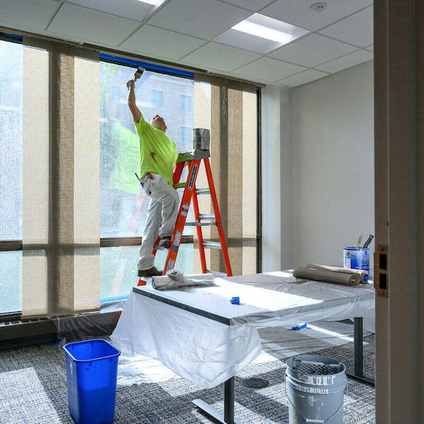 Workers put the finishing touches on the new office space on the first floor of Grace Hall, in the space formerly occupied by Cafe De Grasta. (Photo by Matt Cashore/University of Notre Dame)