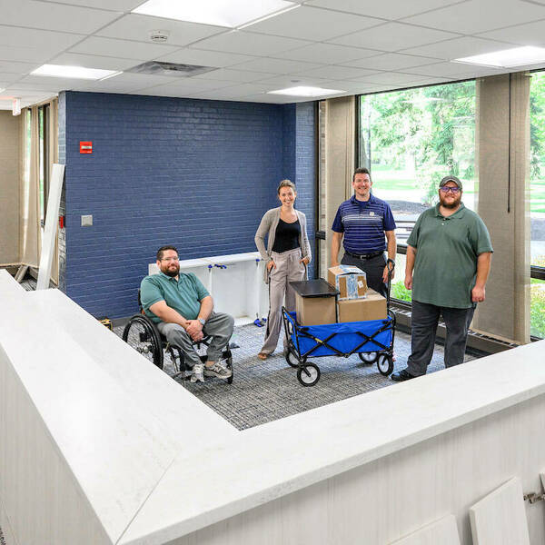 Left to right: Ben Lawecki from Parking Services, Hannah Davis of Human Resources, Mike Hovestol of the Irish1 Card office and Stephen Weaver of the Irish1 Card office pose for a photo in the new office space on the first floor of Grace Hall, in the space formerly occupied by Cafe De Grasta. (Photo by Matt Cashore/University of Notre Dame)