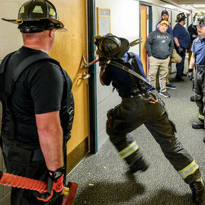 South Bend firefighter practices breaching a door.