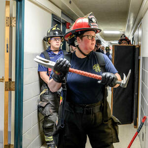 A firefighter prepares to breach a door.